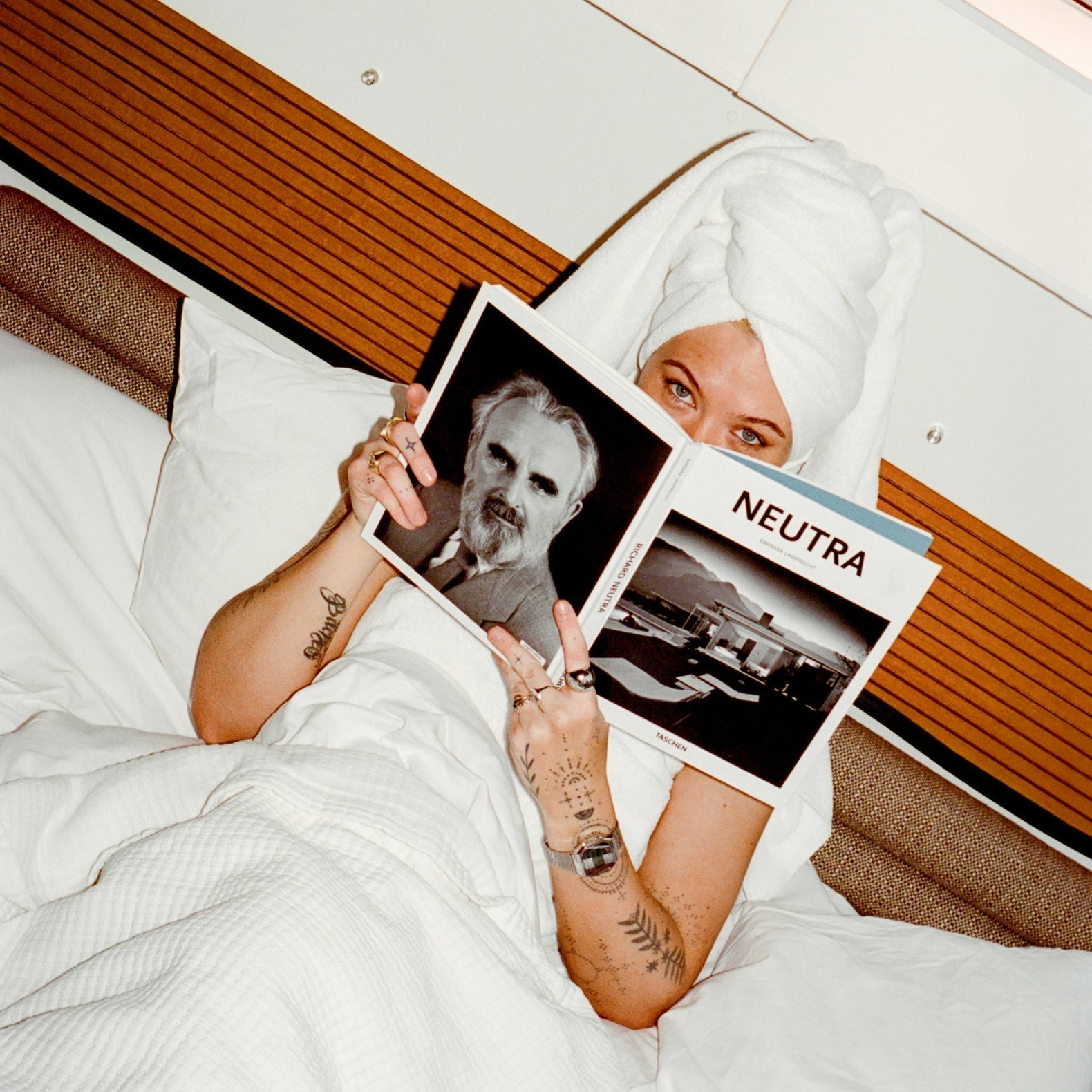 Women reading a book on her bed