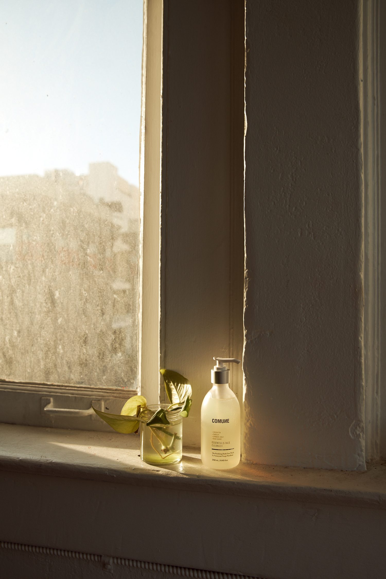 Comune Essentials Face Cleanser near the window