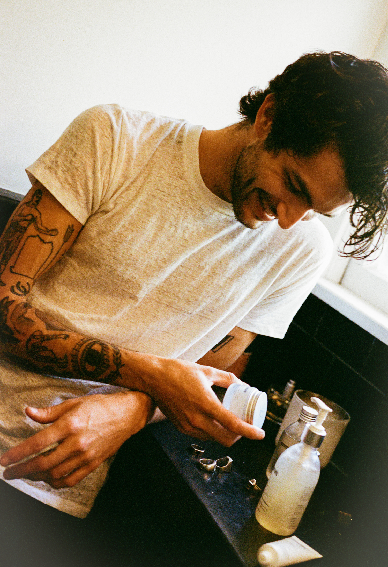 Brandon looking at the skincare before using for his morning routine