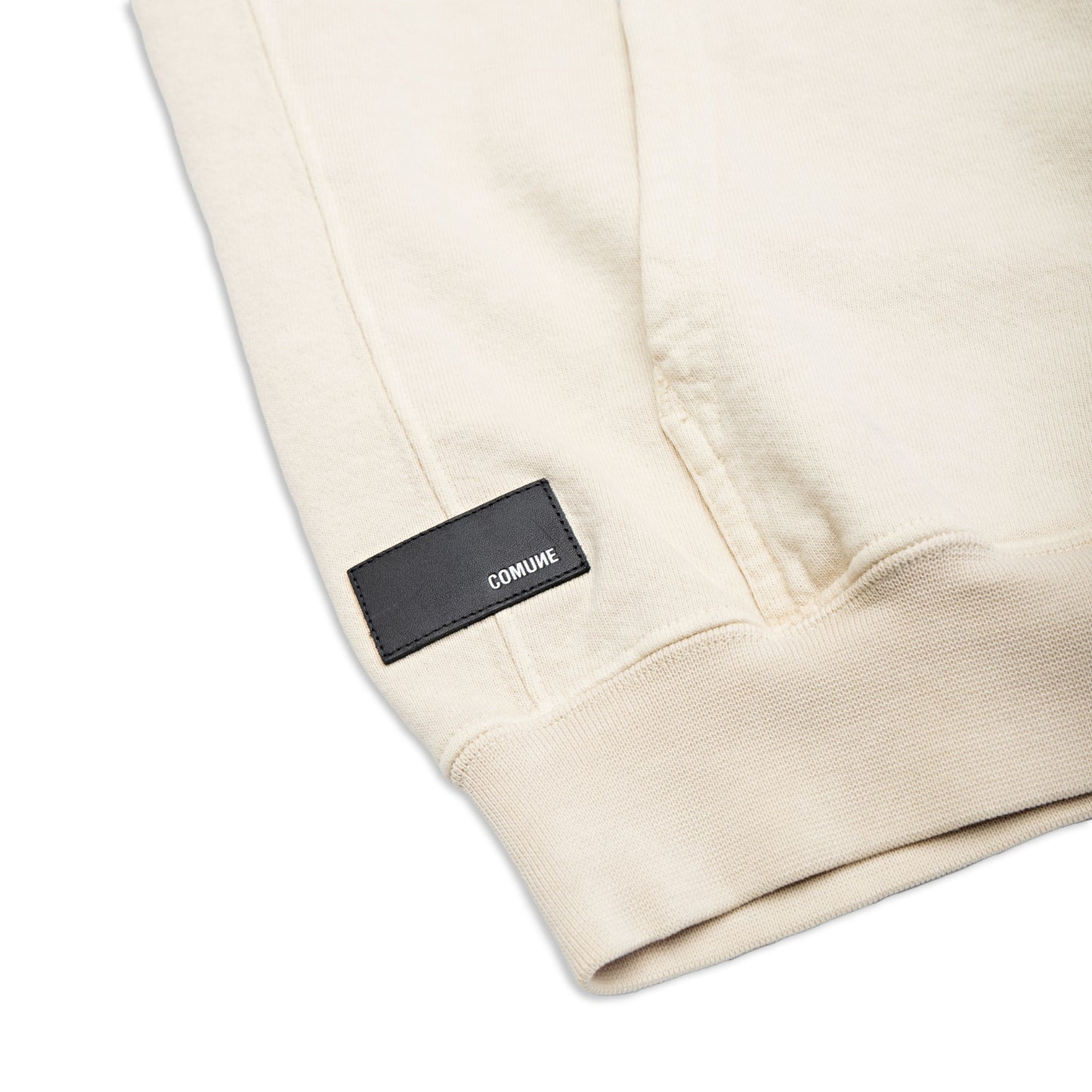 Comune Duke Hoodie heavyweight cotton in bone color on white background, leather patch close up. COMUNE DUKE HOODIE | Bone