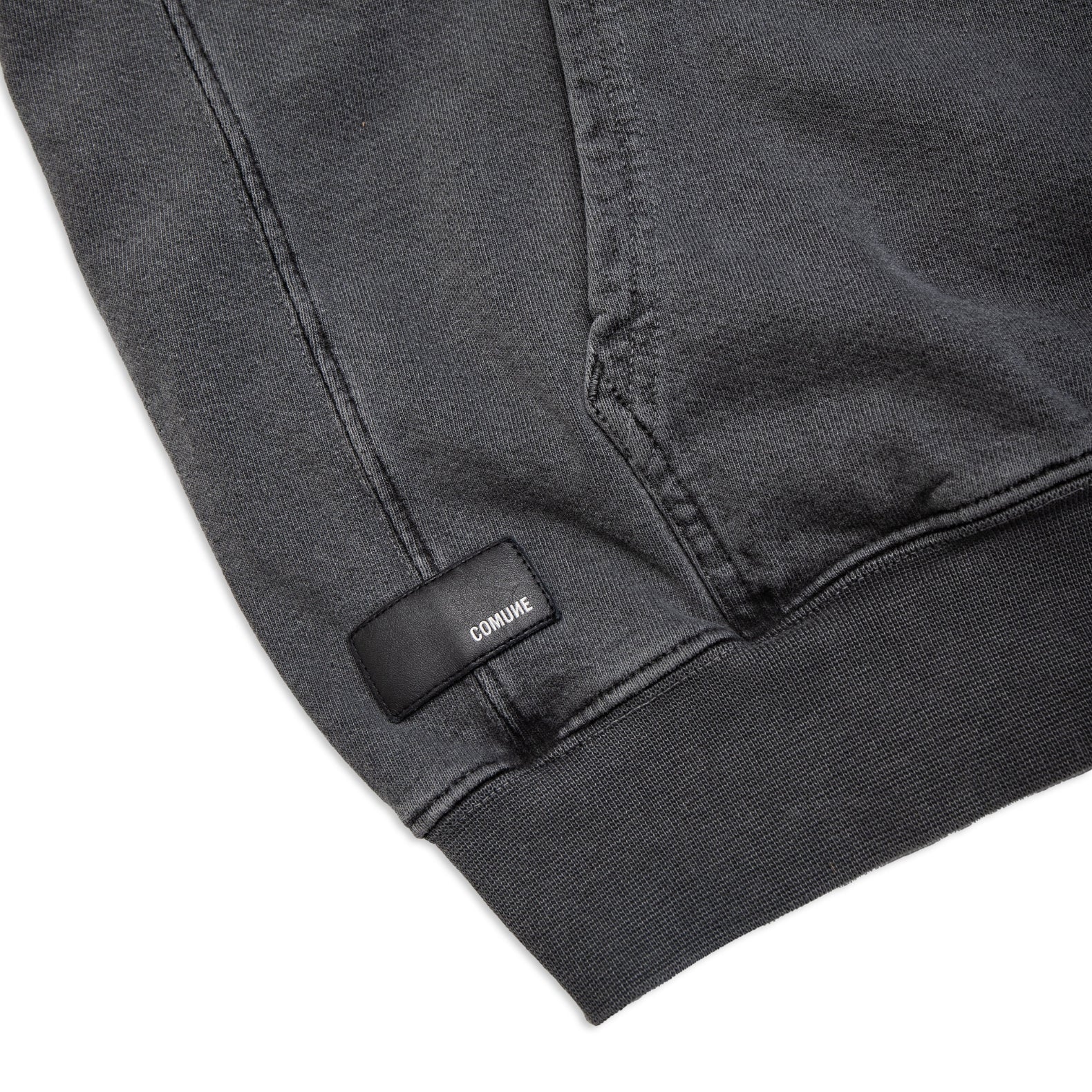 Comune Duke Hoodie heavyweight cotton in camel color on white background, leather patch close up. COMUNE DUKE HOODIE | Faded Black