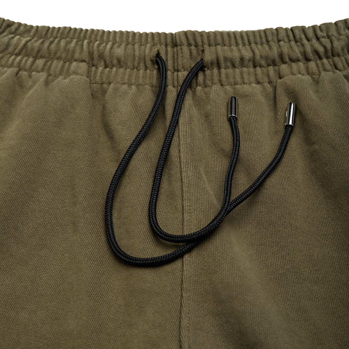 Comune Duke Sweatpants in heavyweight cotton with side gusset in army green color on white background, drawcord close up. COMUNE DUKE SWEATPANTS | Army Green