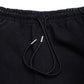 Comune Duke Sweatpants in heavyweight cotton with side gusset in black color on white background, drawcord close up. COMUNE DUKE SWEATPANTS | Black