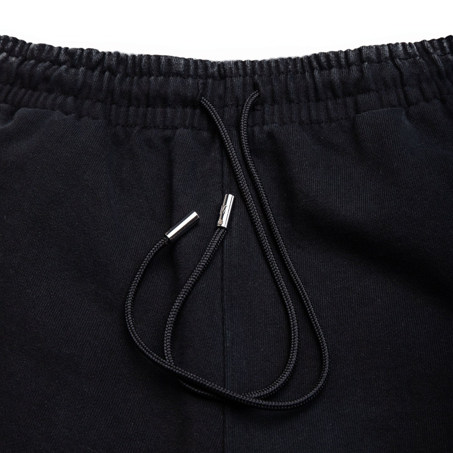 Comune Duke Sweatpants in heavyweight cotton with side gusset in black color on white background, drawcord close up. COMUNE DUKE SWEATPANTS | Black