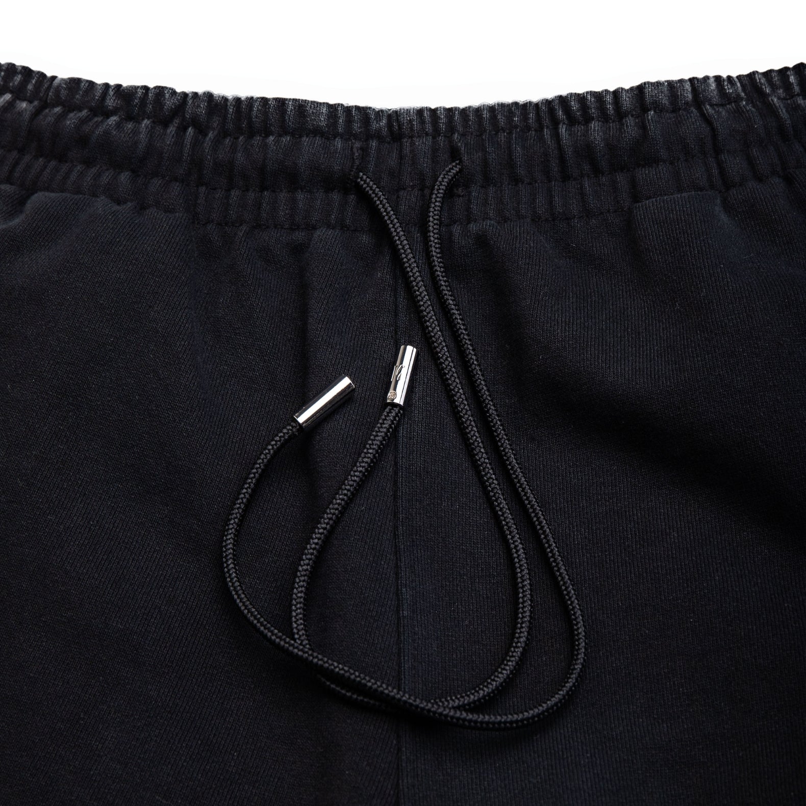 Comune Duke Sweatpants in heavyweight cotton with side gusset in black color on white background, drawcord close up. COMUNE DUKE SWEATPANTS | Black