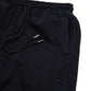 Comune Duke Sweatpants in heavyweight cotton with side gusset in black color on white background, logo close up. COMUNE DUKE SWEATPANTS | Black