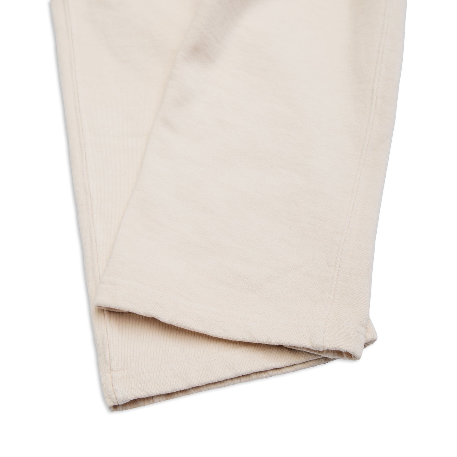 Comune Duke Sweatpants in heavyweight cotton with side gusset in bone color on white background, hem close up. COMUNE DUKE SWEATPANTS | Bone 