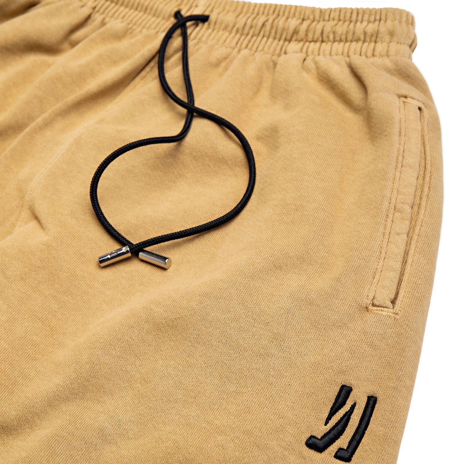 Comune Enzo Joggers heavyweight cotton in acorn color on white background, drawcord close up. COMUNE ENZO JOGGER | Acorn