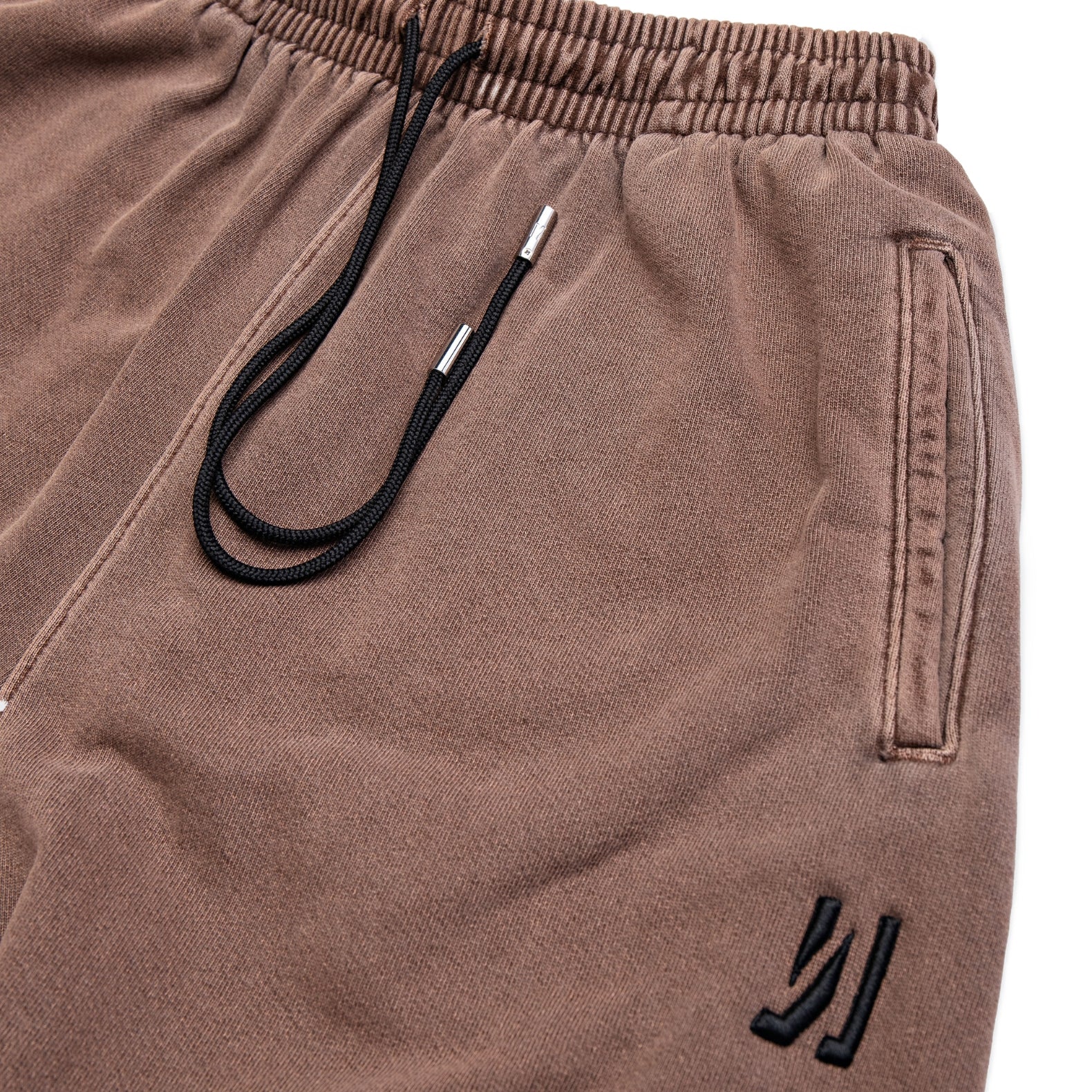 Comune Enzo Joggers heavyweight cotton in brown color on white background, logo close up. COMUNE ENZO JOGGER | Brown