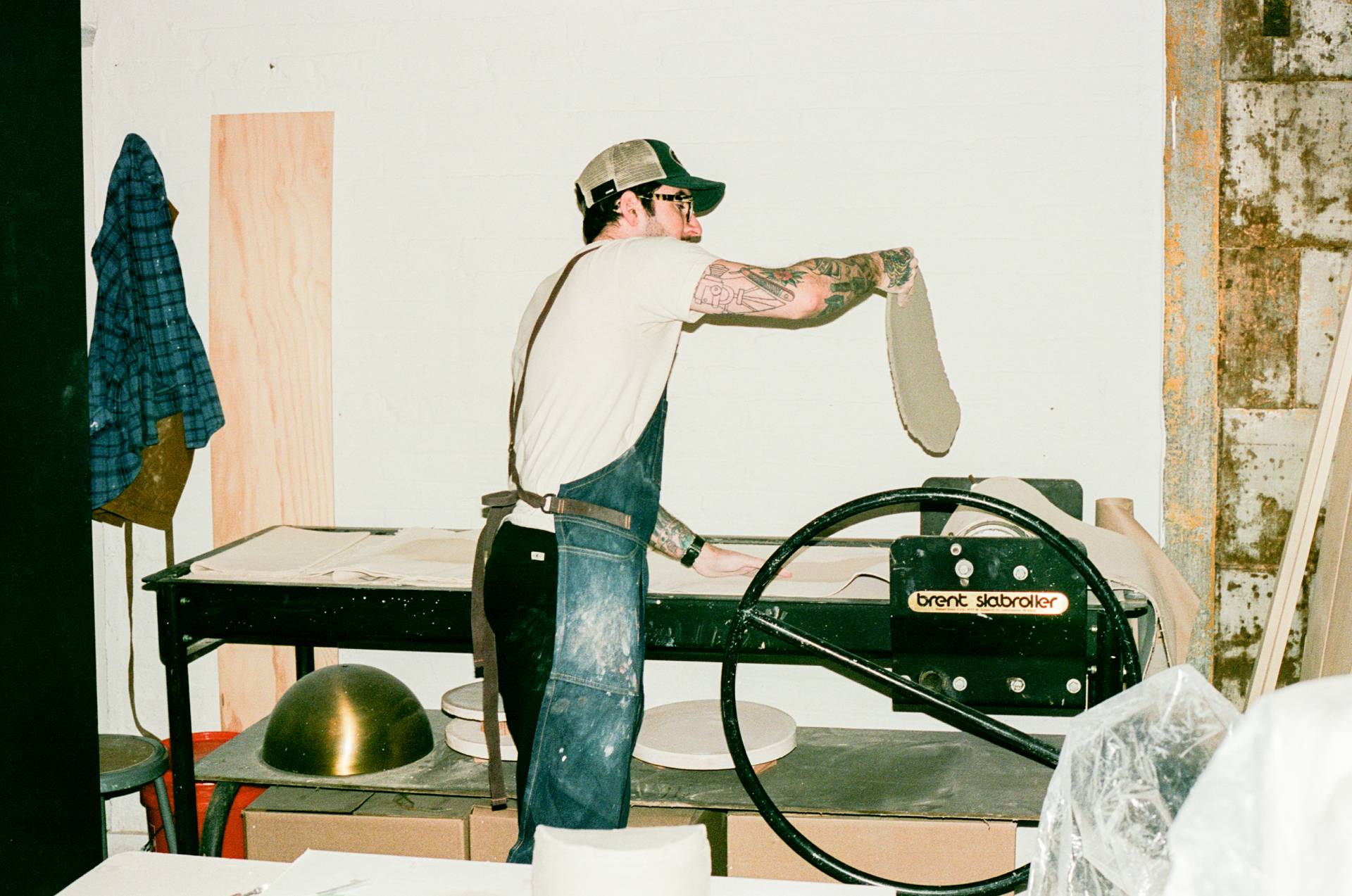 COMUNE artist Ethan Streicher working with a clay object in a workshop setting