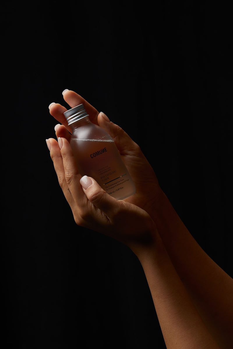 COMUNE FEMALE HANDS OFFERING AHA EXFOLIANT TONER