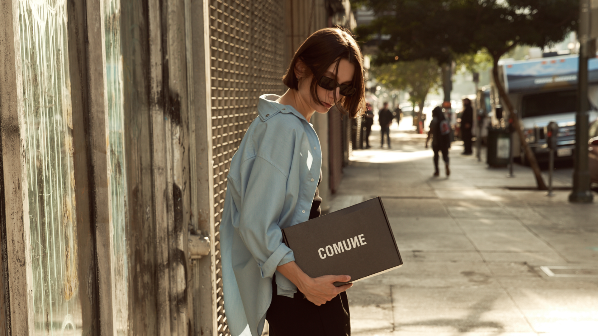 Comune Essentials Collection Kit held by a women