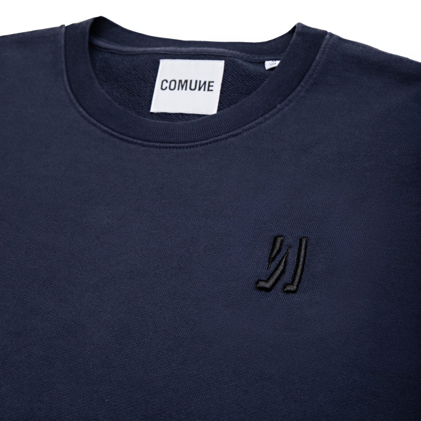 Comune Luka crewneck heavyweight cotton sweatshirt in navy color on white background, logo close up. COMUNE LUKA CREW | Navy