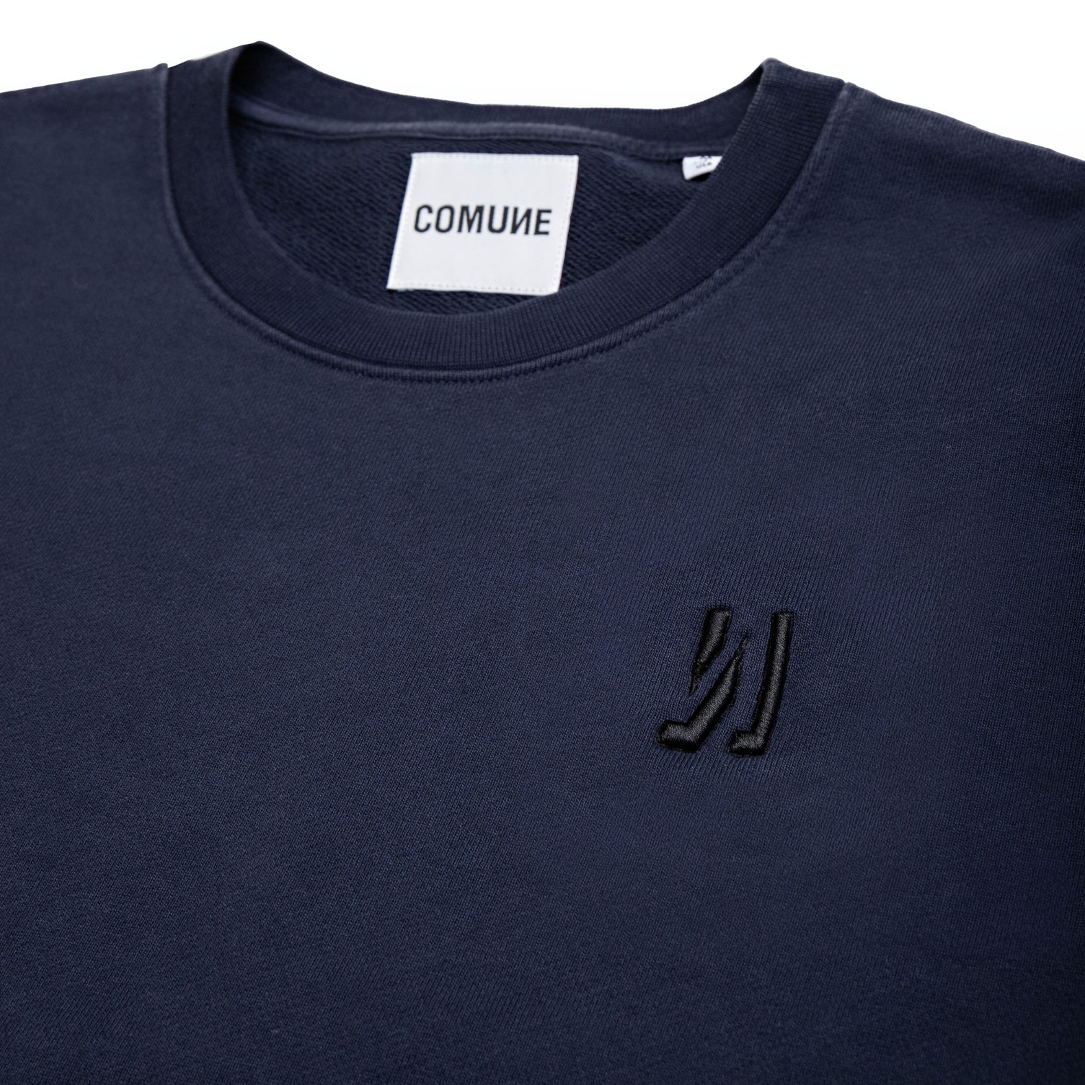 Comune Luka crewneck heavyweight cotton sweatshirt in navy color on white background, logo close up. COMUNE LUKA CREW | Navy