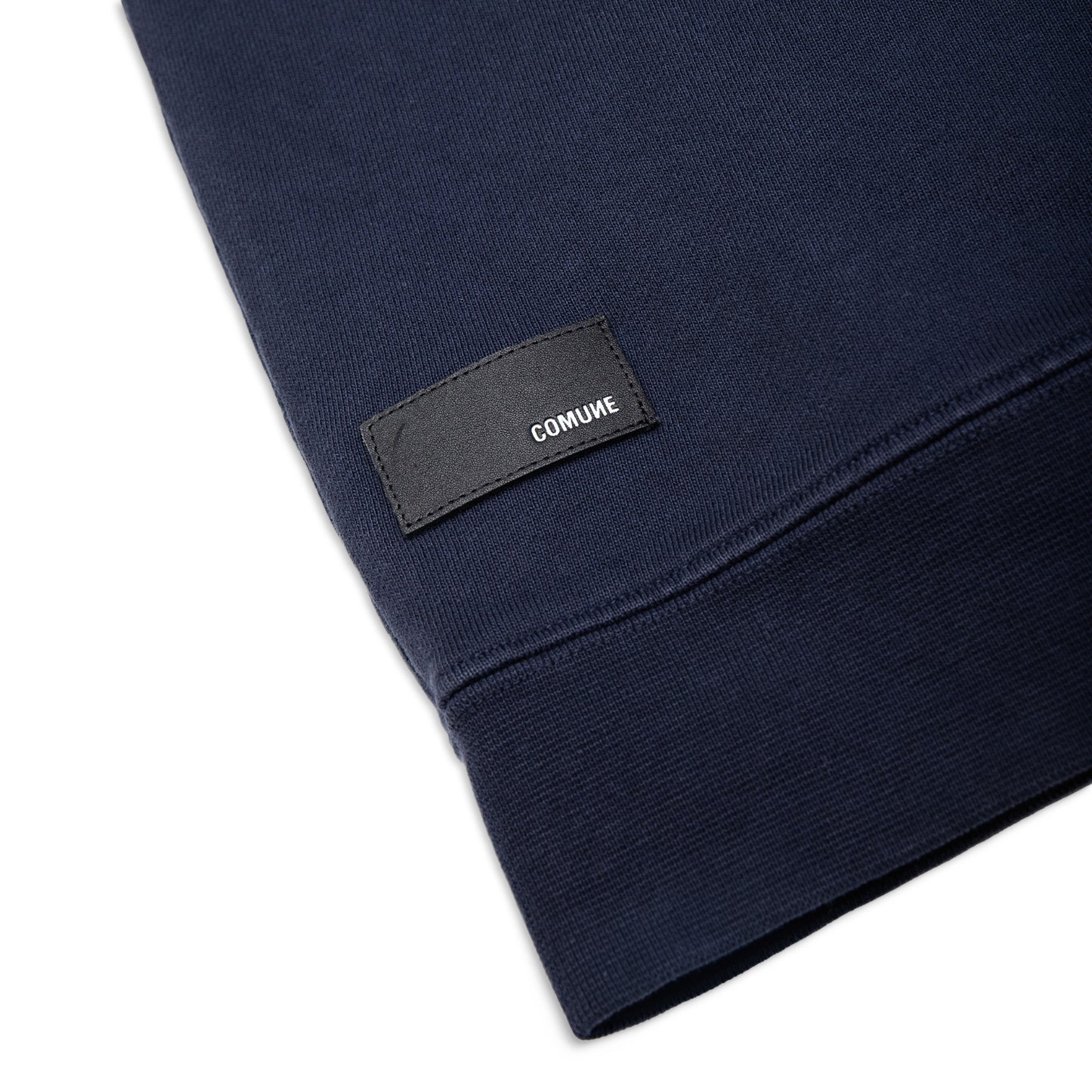 Comune Luka crewneck heavyweight cotton sweatshirt in navy color on white background, leather patch close up. COMUNE LUKA CREW | Navy