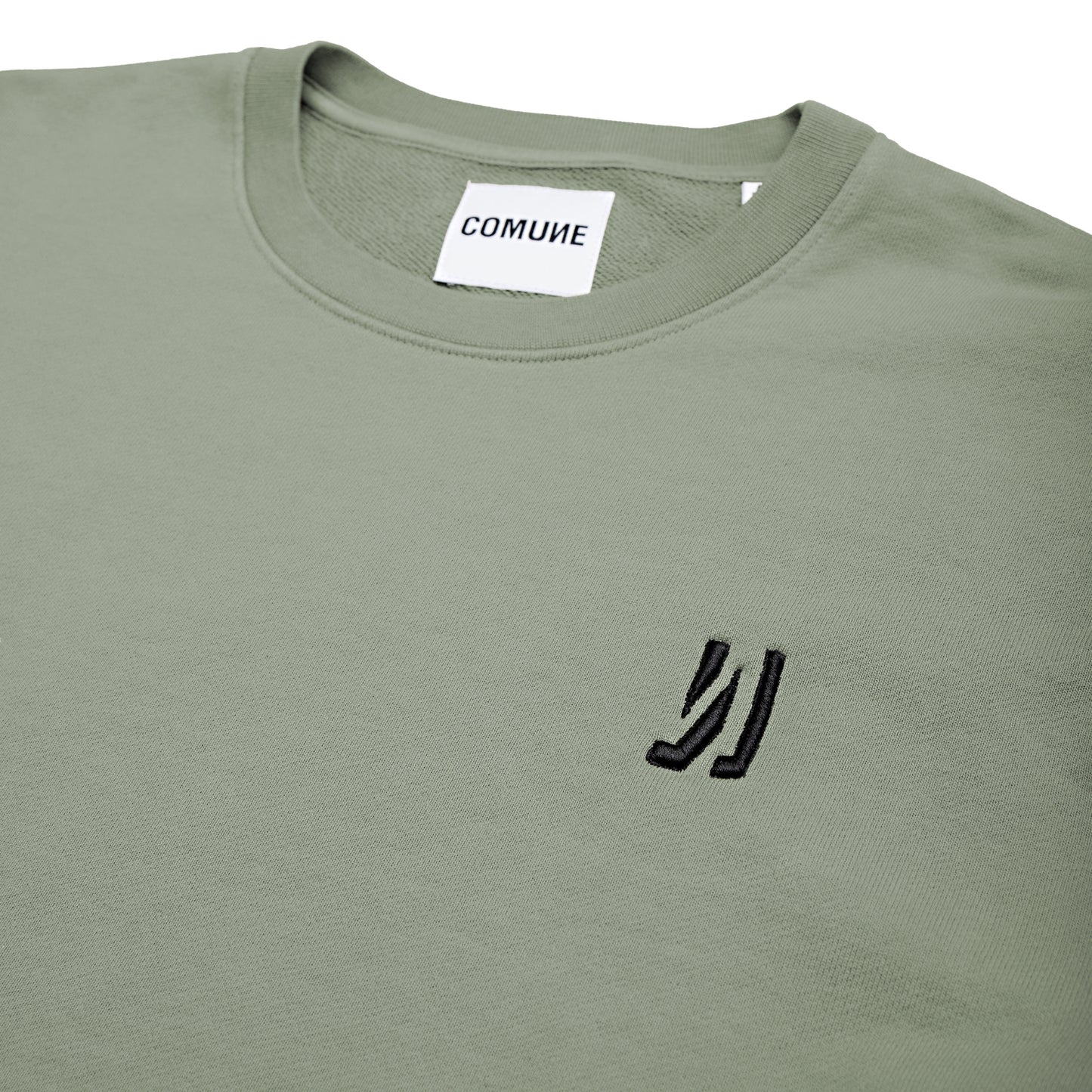 Comune Luka crewneck heavyweight cotton sweatshirt in sage color on white background, logo close up. COMUNE LUKA CREW | Sage