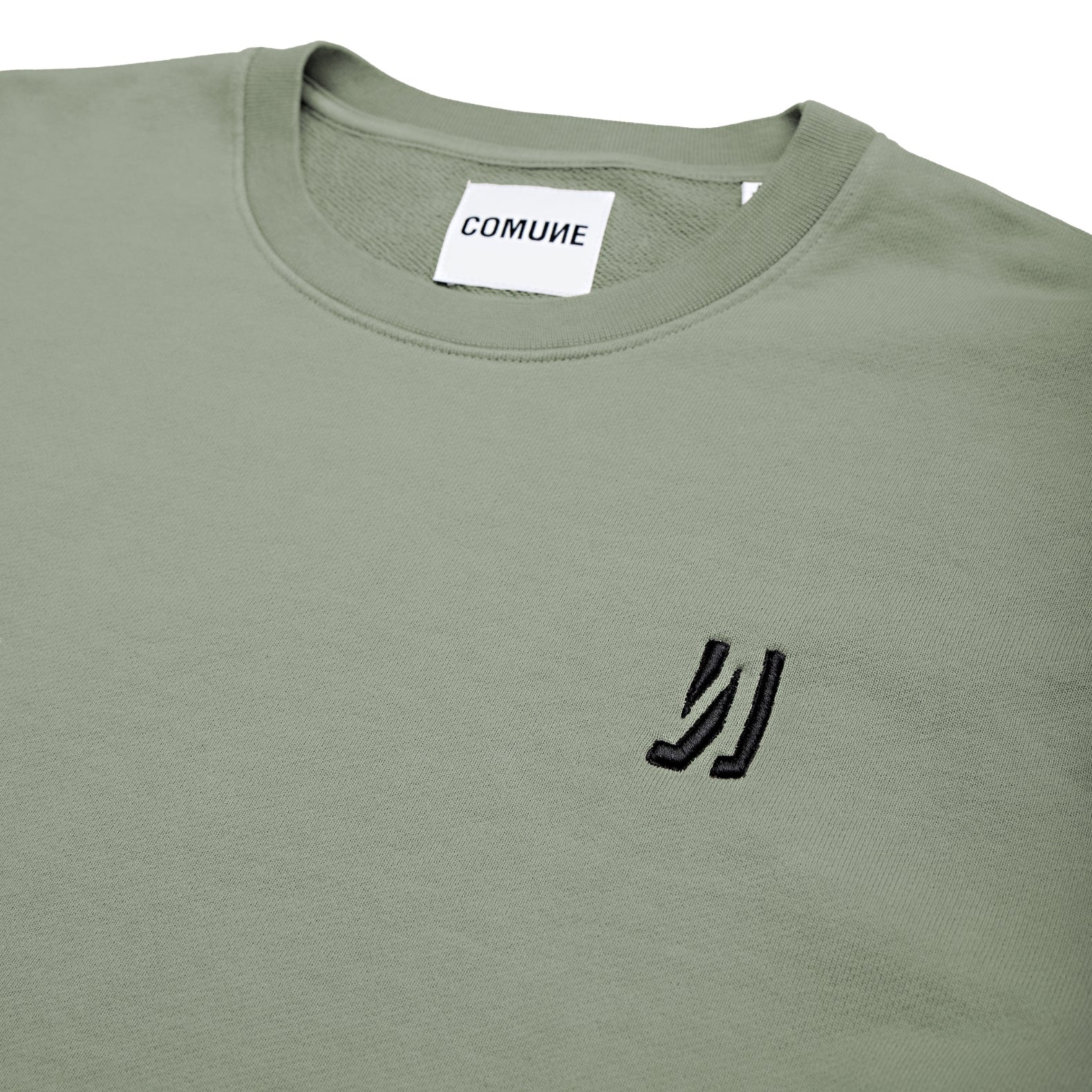 Comune Luka crewneck heavyweight cotton sweatshirt in sage color on white background, logo close up. COMUNE LUKA CREW | Sage