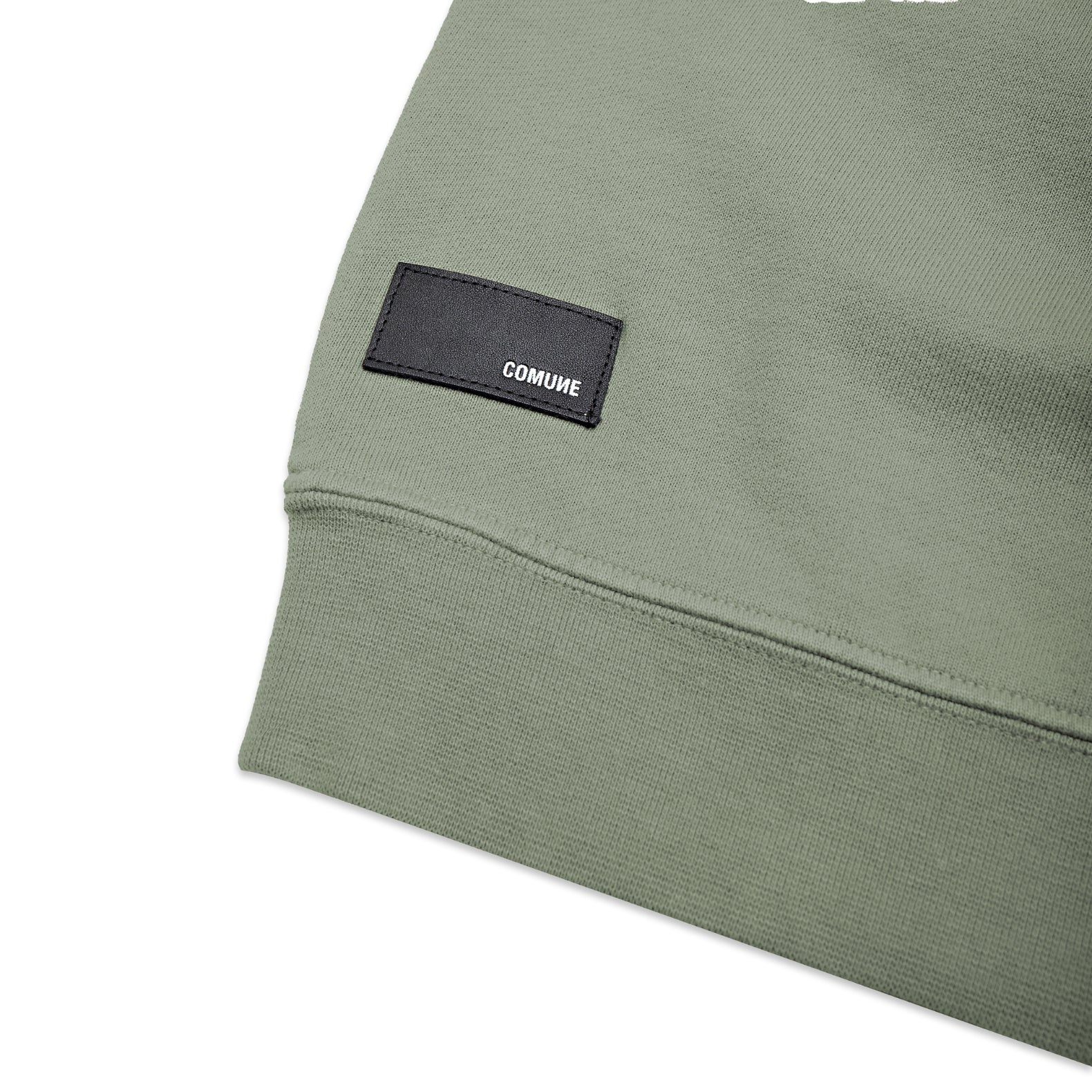 Comune Luka crewneck heavyweight cotton sweatshirt in sage color on white background, logo close up. COMUNE LUKA CREW | Sage