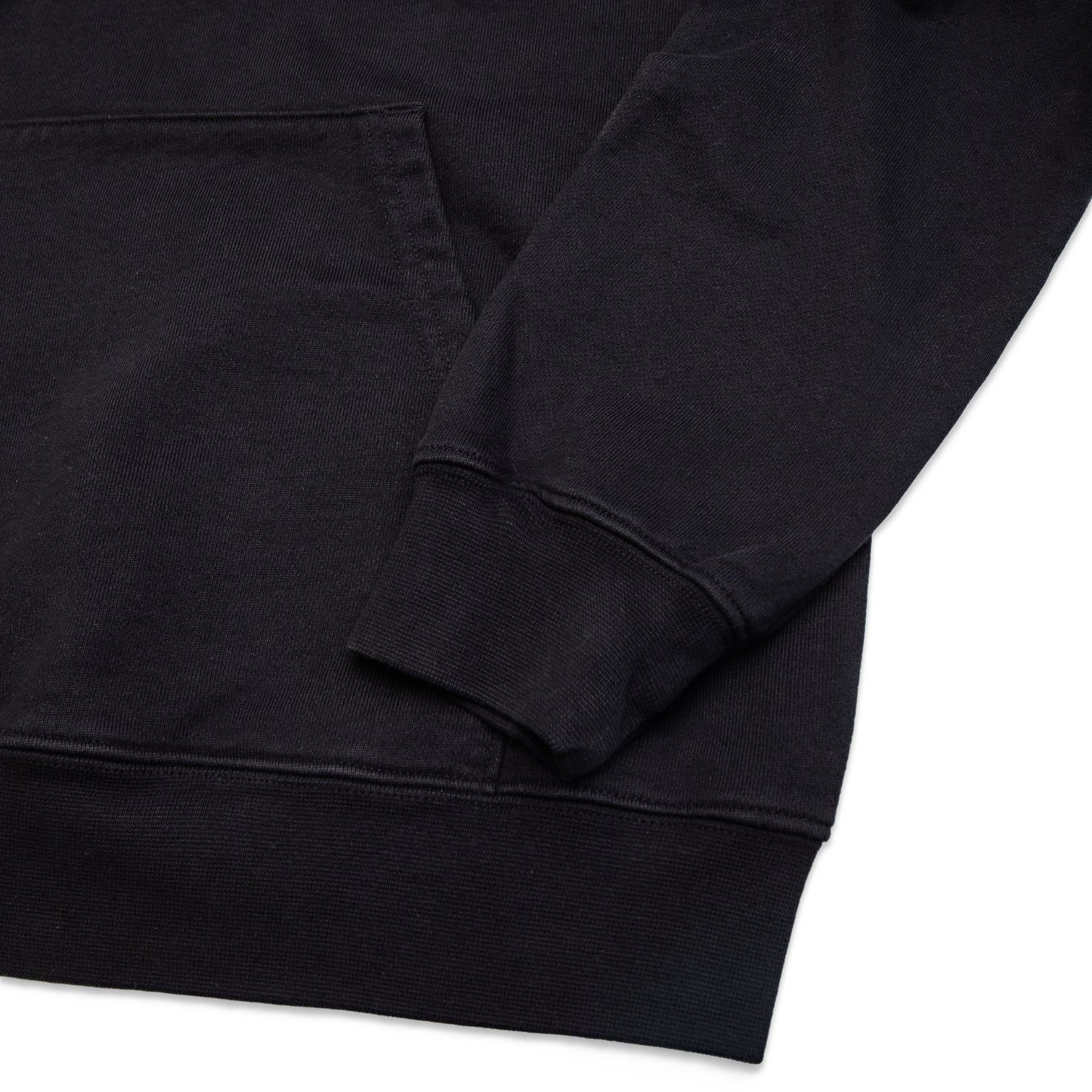 Comune Luka Hoodie heavyweight cotton sweatshirt in black color on white background, hem close up. COMUNE LUKA HOODIE | Black