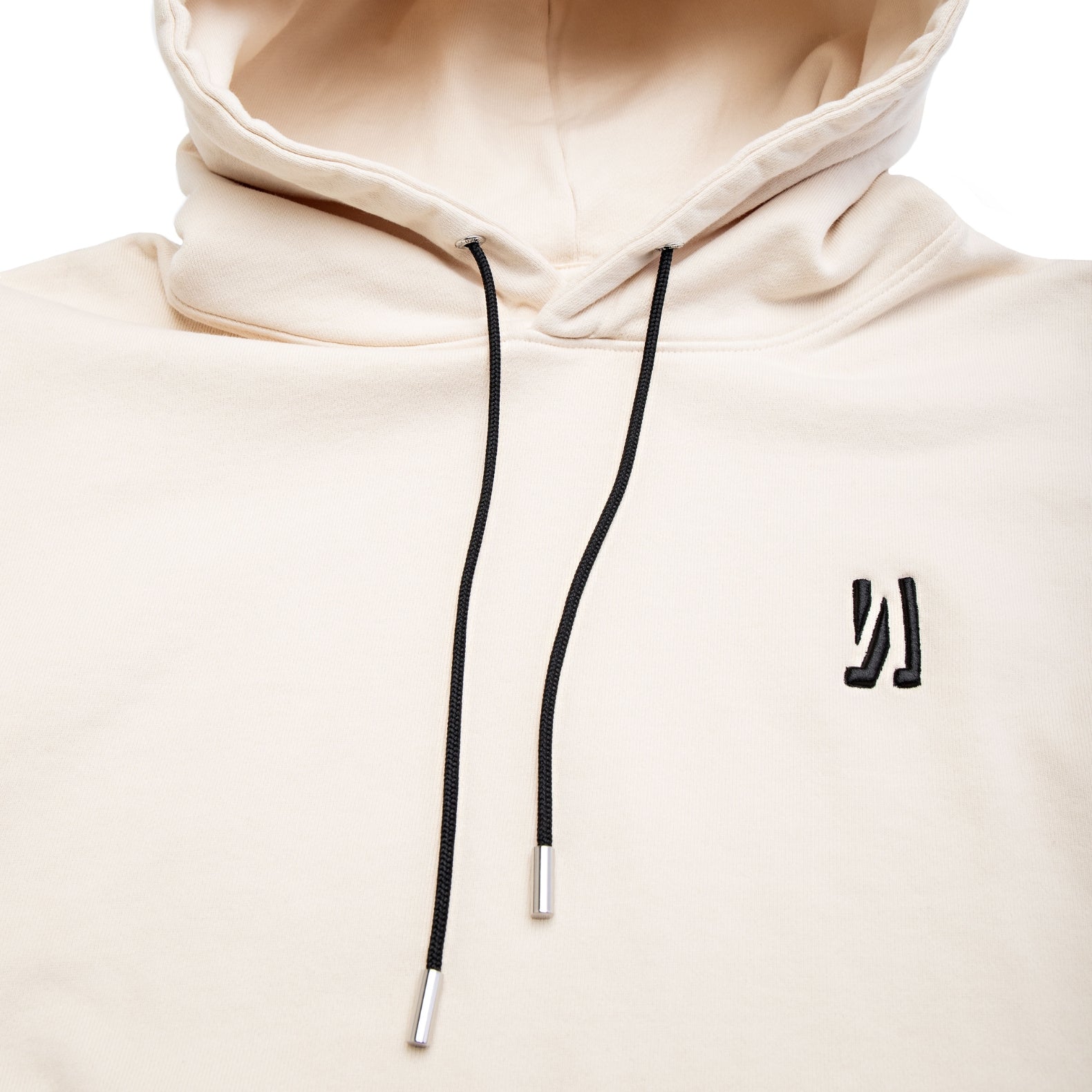 Comune Luka Hoodie heavyweight cotton sweatshirt in bone color on white background, logo close up. COMUNE LUKA HOODIE | Bone