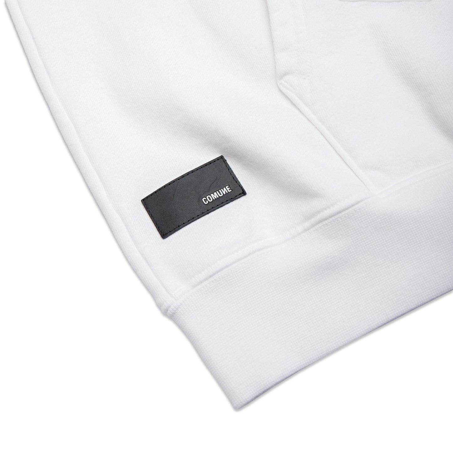 Comune Luka Hoodie heavyweight cotton sweatshirt in white color on white background, leather patch close up. COMUNE LUKA HOODIE | White