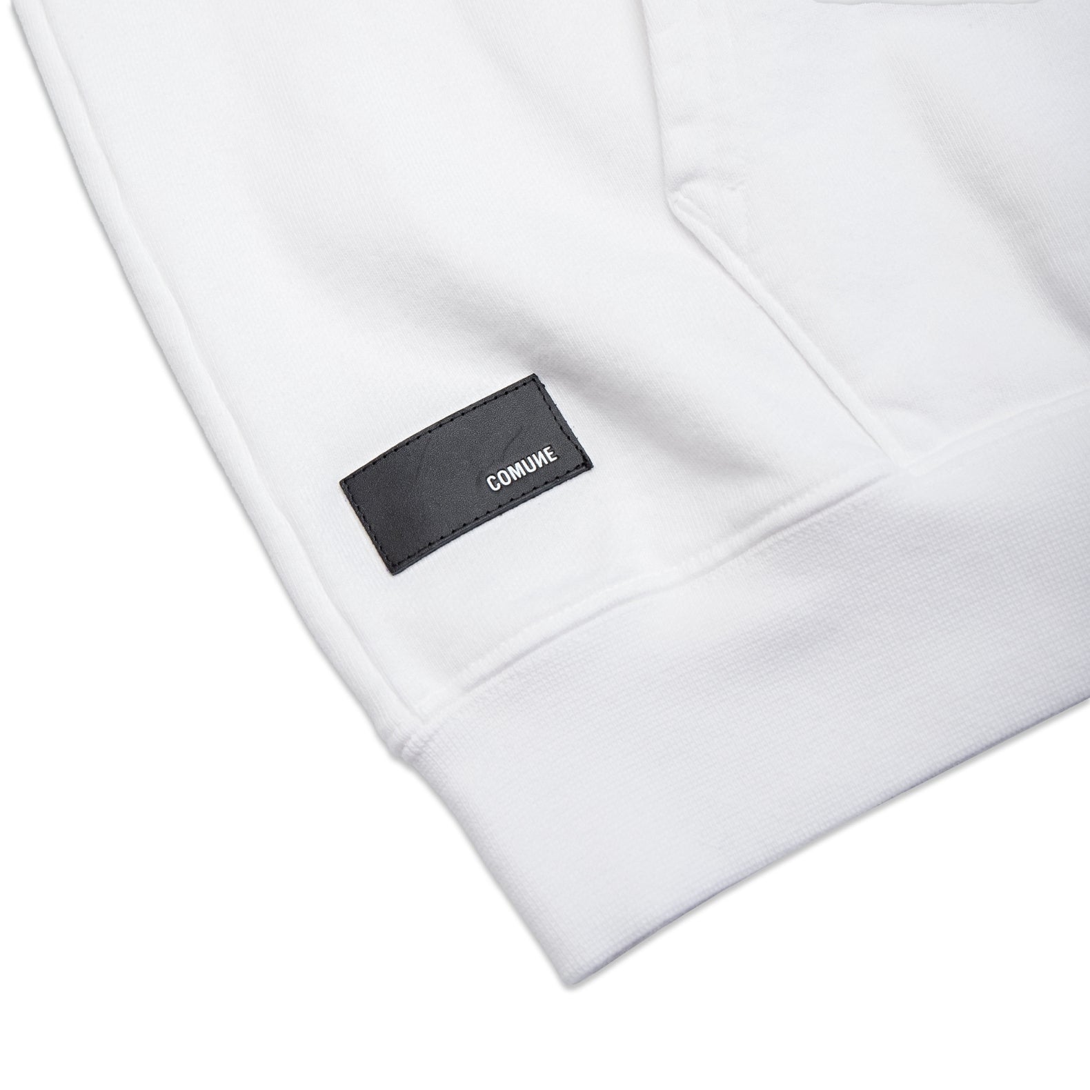 Comune Luka Hoodie heavyweight cotton sweatshirt in white color on white background, leather patch close up. COMUNE LUKA HOODIE | White