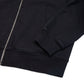 Comune Luka Zip-up heavyweight cotton hoodie in black color on a white background, hem close up. COMUNE LUKA ZIP-UP | Black