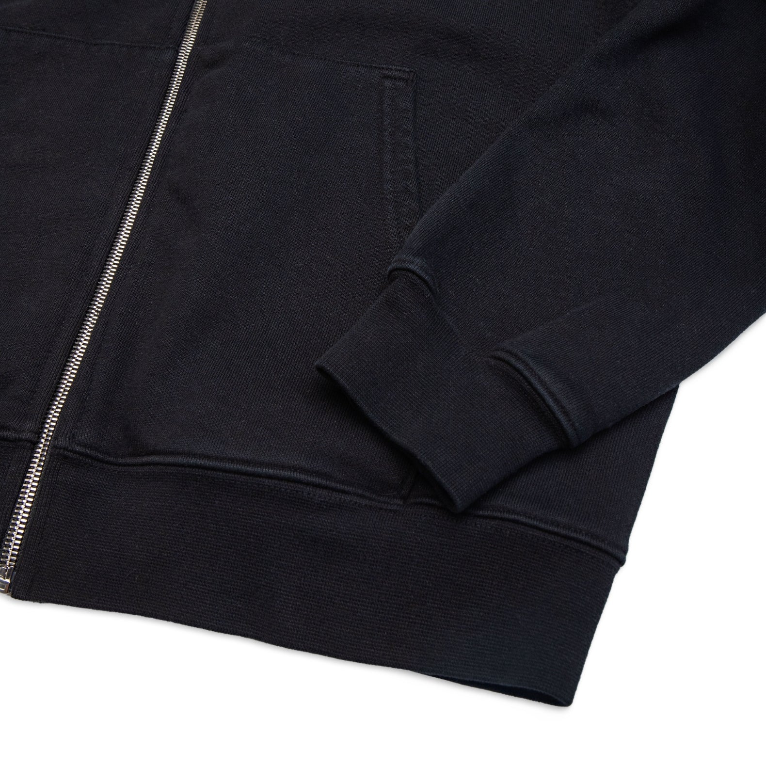 Comune Luka Zip-up heavyweight cotton hoodie in black color on a white background, hem close up. COMUNE LUKA ZIP-UP | Black