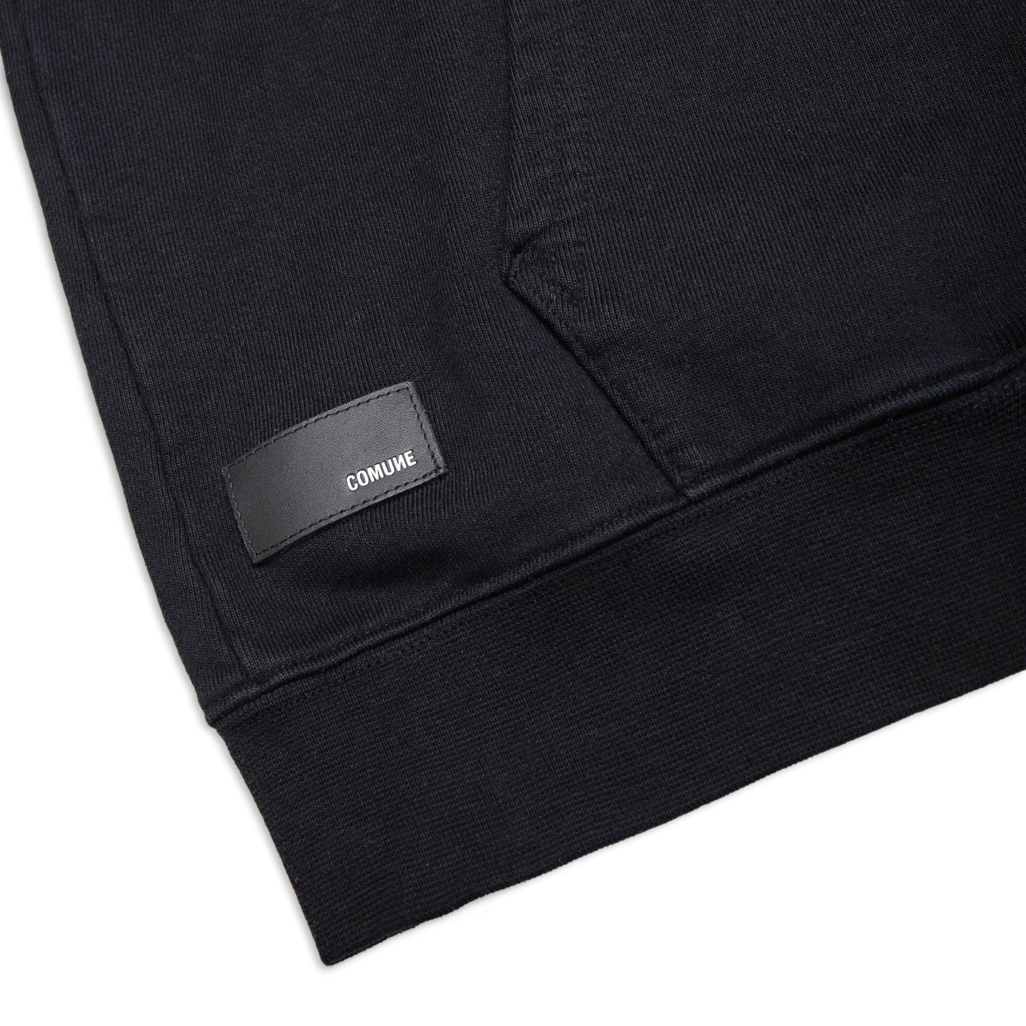 Comune Luka Zip-up heavyweight cotton hoodie in black color on a white background, leather patch close up. COMUNE LUKA ZIP-UP | Black