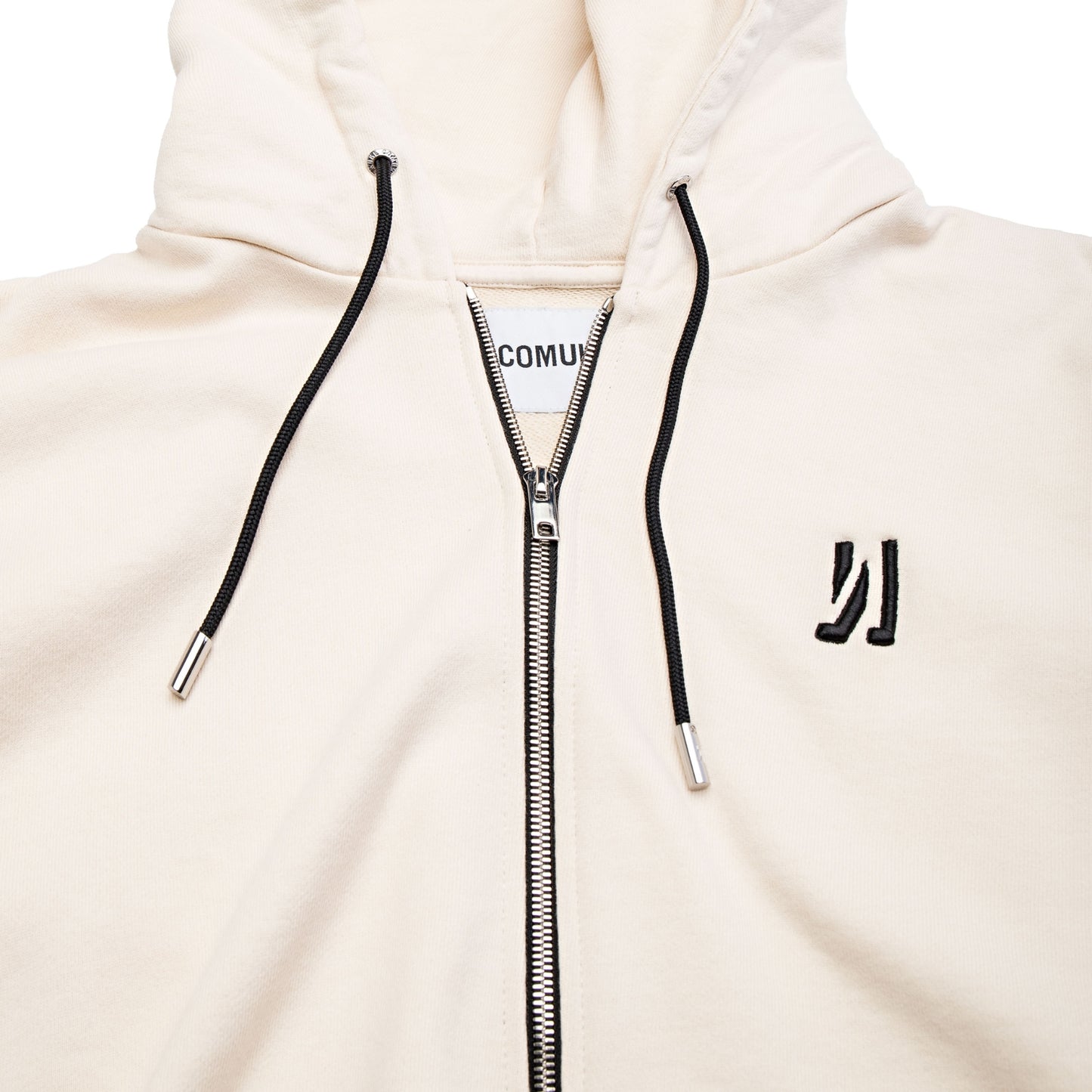 Comune Luka Zip-up in heavyweight cotton hoodie in bone color on white background, logo close up. COMUNE LUKA ZIP-UP | Bone