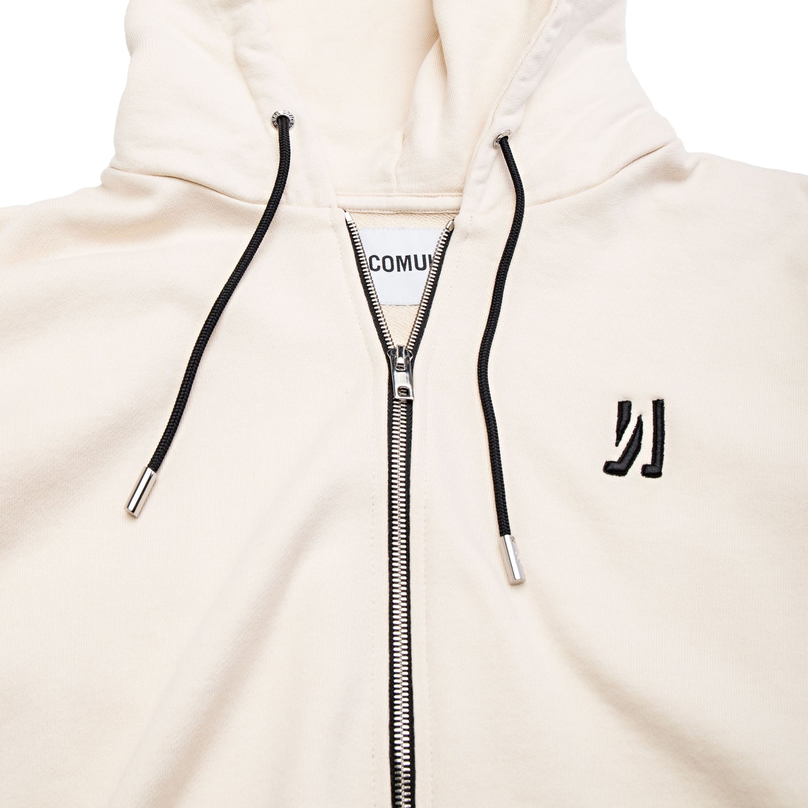 Comune Luka Zip-up in heavyweight cotton hoodie in bone color on white background, logo close up. COMUNE LUKA ZIP-UP | Bone
