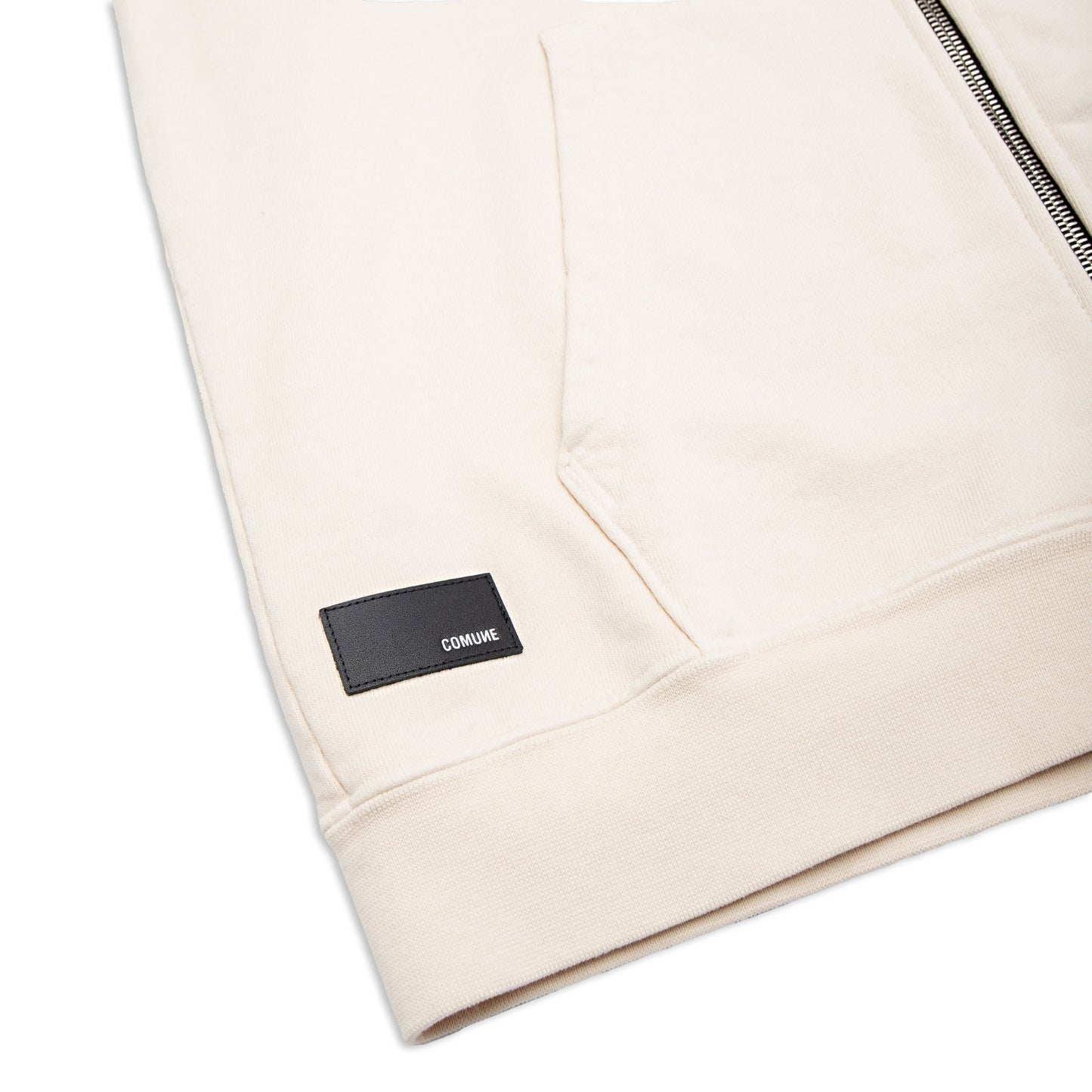 Comune Luka Zip-up in heavyweight cotton hoodie in bone color on white background, leather logo close up. COMUNE LUKA ZIP-UP | Bone
