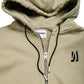 Comune Luka Zip-up in heavyweight cotton hoodie in sage color on white background, logo close up. COMUNE LUKA ZIP-UP | Sage