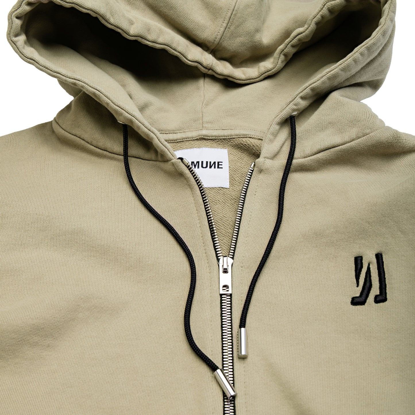 Comune Luka Zip-up in heavyweight cotton hoodie in sage color on white background, logo close up. COMUNE LUKA ZIP-UP | Sage