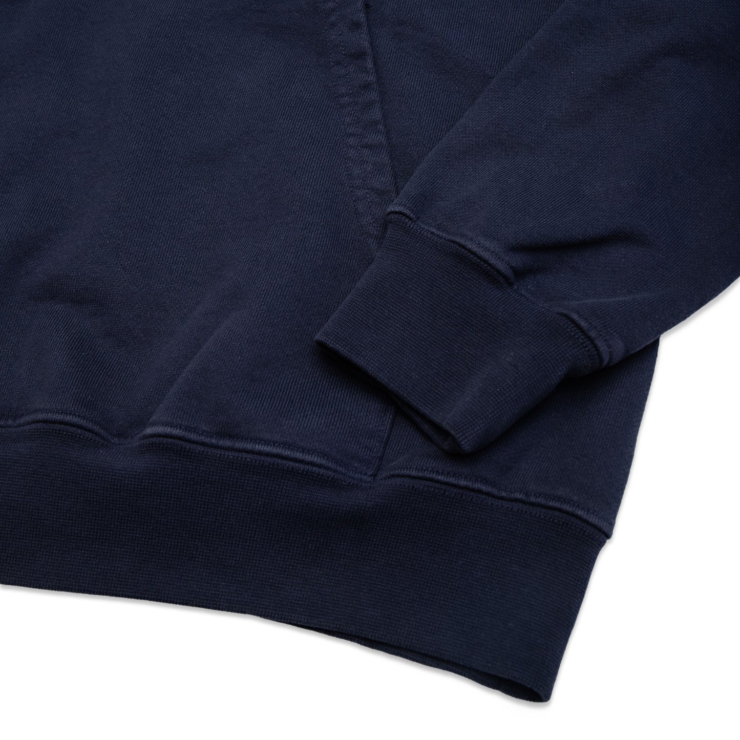 Comune Luka Hoodie heavyweight cotton sweatshirt in navy color on white background, hem close up. COMUNE LUKA HOODIE | Navy