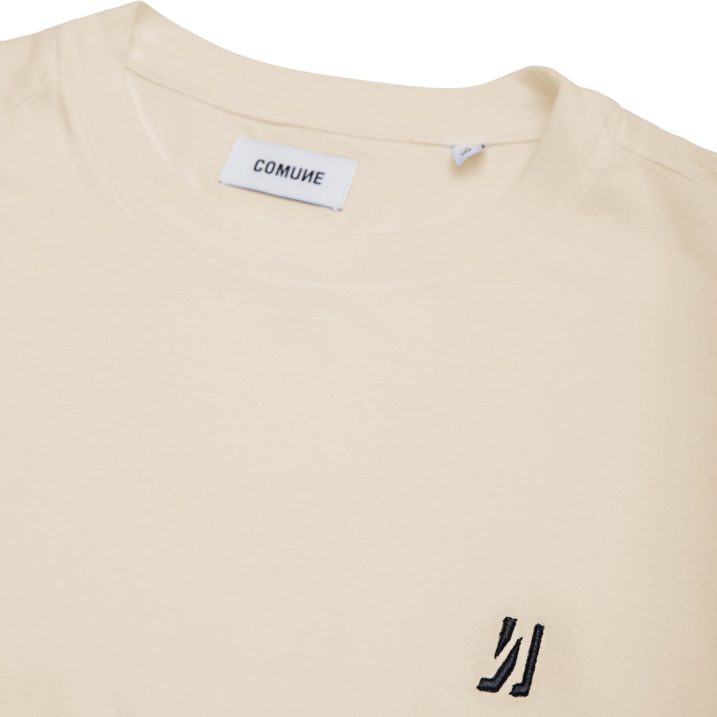 Comune Nori oversized tee in soft 100% supima cotton in bone color on white background, logo close up. COMUNE NORI OVERSIZED TEE | Bone
