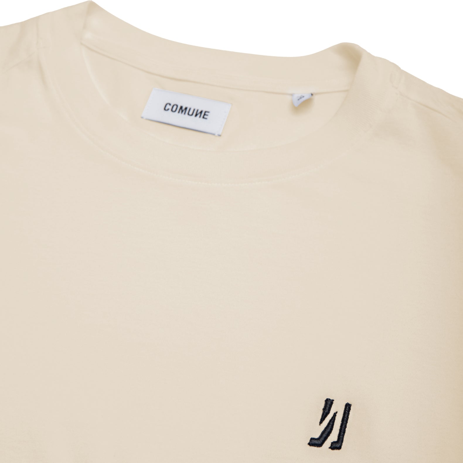 Comune Nori oversized tee in soft 100% supima cotton in bone color on white background, logo close up. COMUNE NORI OVERSIZED TEE | Bone