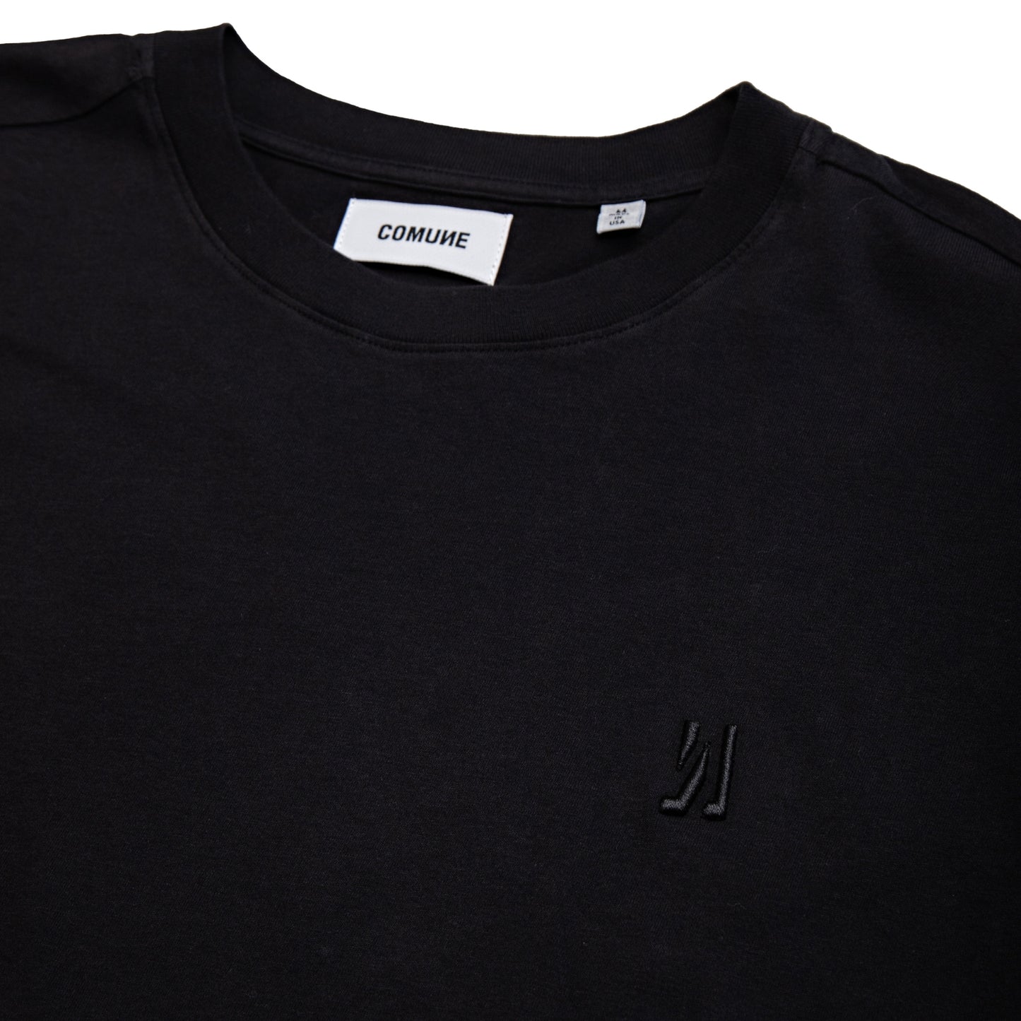 Comune Nori tee in soft 100% supima cotton in black color on white background, logo close up. COMUNE NORI TEE | Black