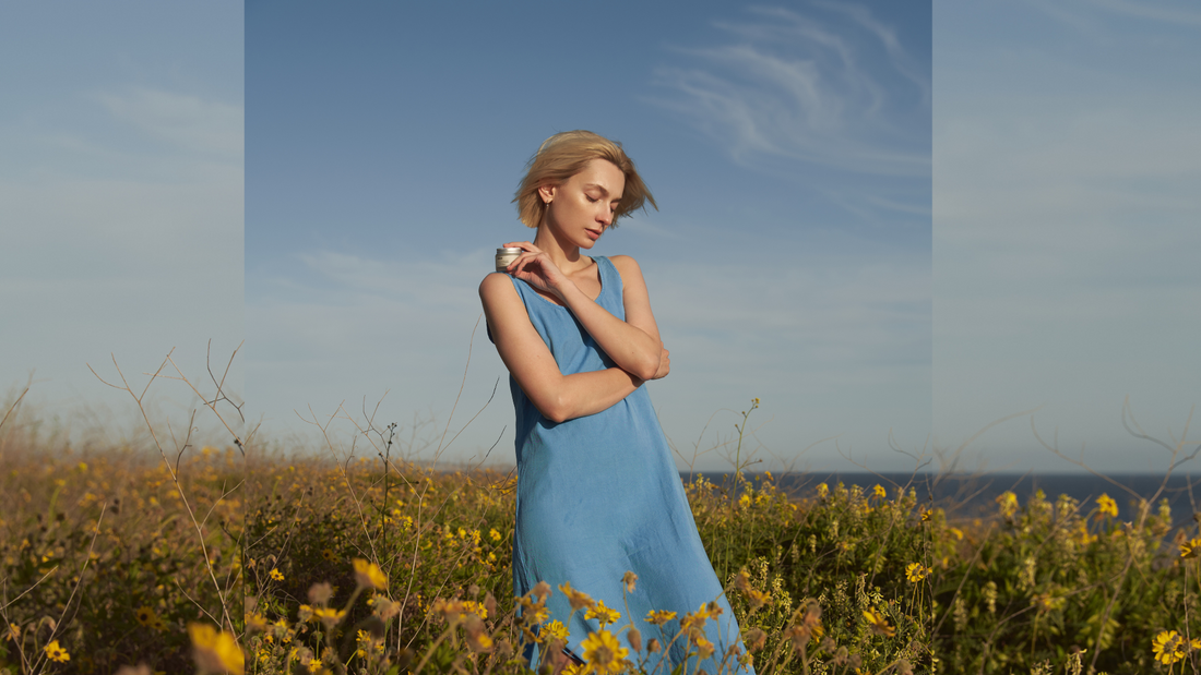 Comune Revitalize Overnight Mask held by a women in the flower fields near the ocean