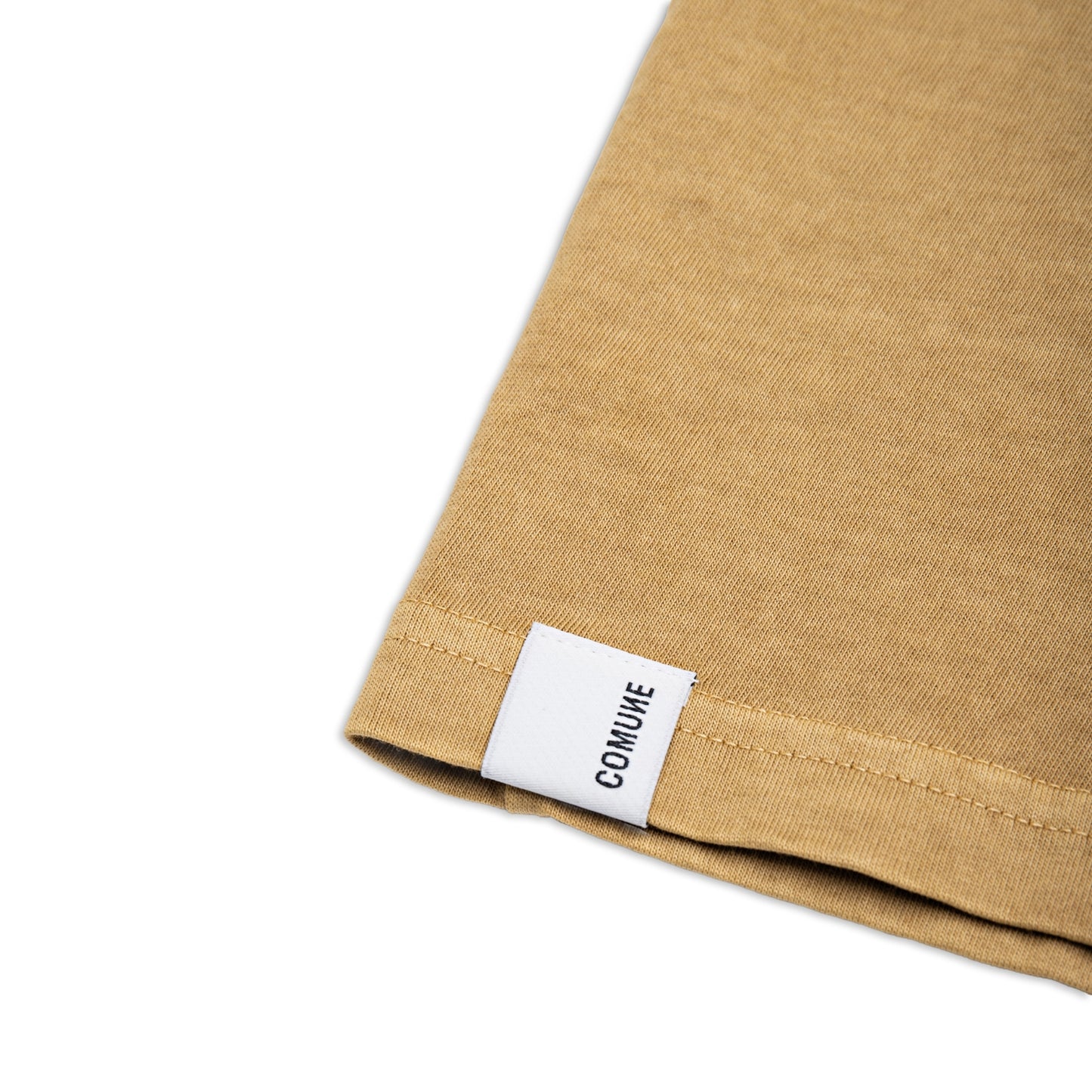 Comune Ryder tee in soft 100% cotton in acorn color on white background, label and hem close up. COMUNE RYDER TEE | Acorn