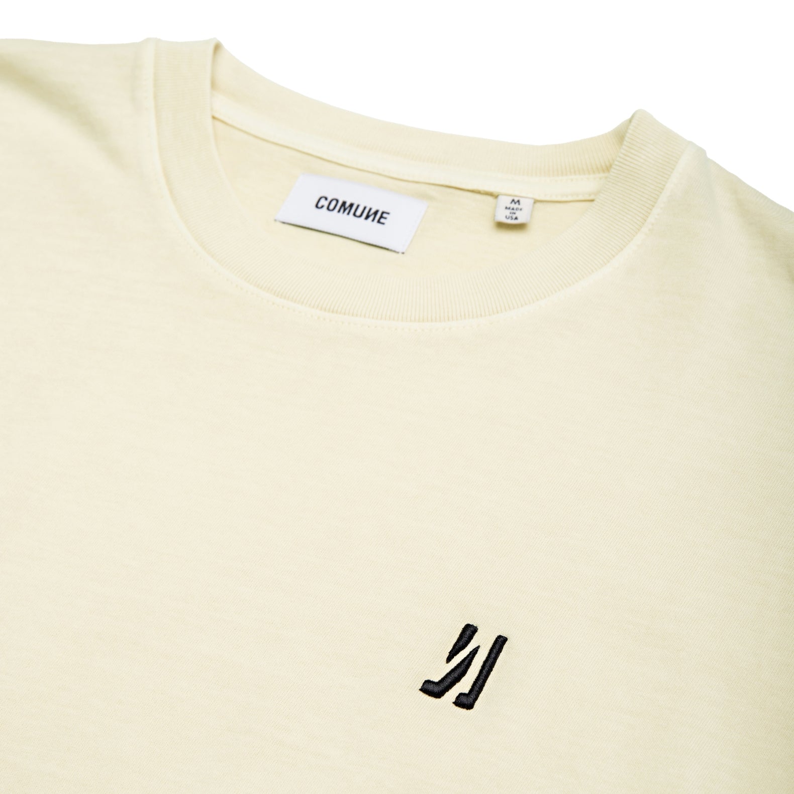 Comune Ryder tee in soft 100% cotton in bone color on white background, logo close up. COMUNE RYDER TEE | Bone