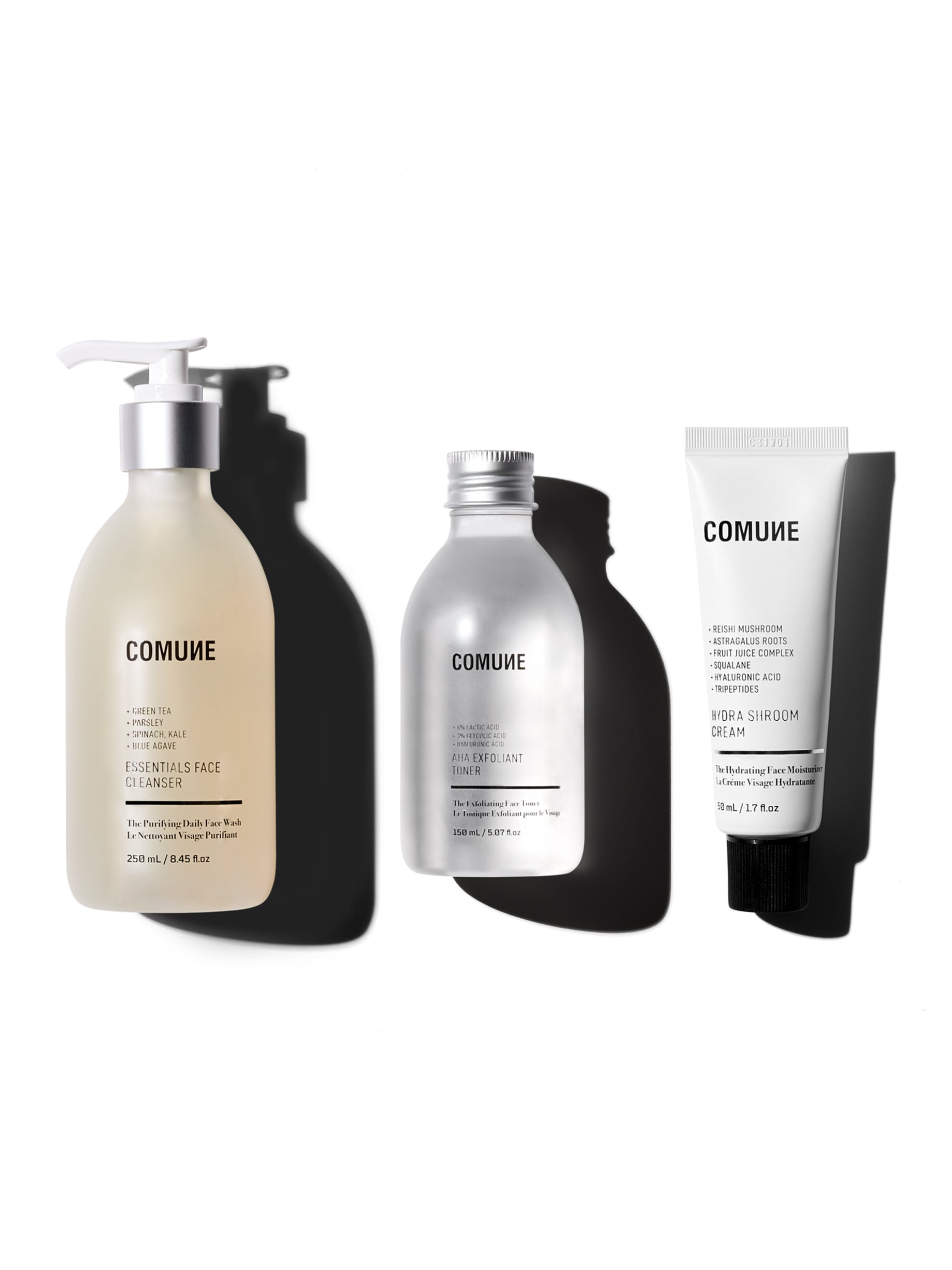 COMUNE Clear + Nourish skincare trio on a white background. Essentials Face Cleanser | AHA Exfoliant Toner | Hydra Shroom Cream