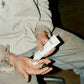 COMUNE artist Lizz Jardim  applying comune's Hydra Shroom cream to their hand.